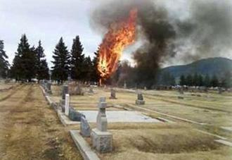 Flames and billowing smoke rise after a single-engine private passenger plane crashed into a cemetery, on approach to an airport in Butte, Montana, killing 17 people, March 22, 2009. REUTERS