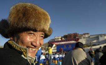 A Tibetan man smiles prior to the celebration ceremony to mark the first Serfs Emancipation Day in front of Potala Palace in Lhasa, capital of southwest China's Tibet Autonomous Region, on March 28, 2009. A grand celebration ceremony will be held here at 10:00 a.m. local time Saturday to mark the first Serfs Emancipation Day.(Xinhua/Purbu Zhaxi)