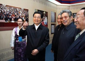 Chinese President Hu Jintao, also general secretary of the Communist Party of China (CPC) Central Committee and chairman of the Central Military Commission, visits an exhibition marking the 50th Anniversary of Democratic Reform in Tibet, at the Cultural Palace of Nationalities in Beijing, capital of China, on March 27, 2009.(Xinhua Photo)