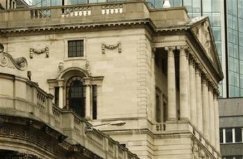 A security man, left, looks out from a roof of the Bank of England in the City of London, Monday, March 30, 2009. Anti-globalisation, anti-capitalist and environmental protests are been planned, targeting the City and its financial institutions, during the G20 Financial Summit to be held on Thursday, in London.(AP Photo / Sang Tan)