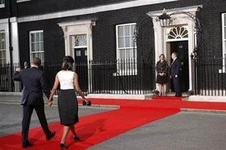 President Barack Obama and first lady Michelle Obama walk on the red carpet to be greeted by British Prime Minister Gordon Brown, and his wife Sarah Brown at Number 10 Downing Street in London, Wednesday, April 1, 2009, for the G-20 working dinner. (AP Photo/Pablo Martinez Monsivais)