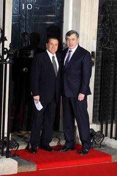 British Prime Minister Gordon Brown (R) shakes hands with Italian Premier Silvio Berlusconi at No. 10 Downing Street in London April 1, 2009. Brown hosted a working dinner for the leaders attending the Group of 20 Countries (G20) summit at No. 10 Downing Street April 1, 2009. The G20 Summit on Financial Markets and World Economy will be held in London on April 2. (Xinhua/Pool)