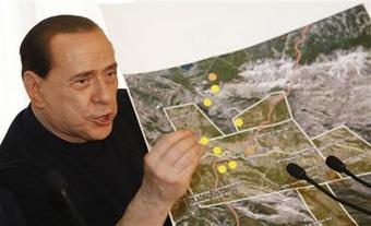 Italian premier Silvio Berlusconi shows a map of the earthquake zone during a news conference in L 'Aquila, central Italy, Wednesday , April 8, 2009.(AP Photo/Luca Bruno)