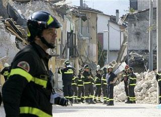 Firefighters inspect the devastated village of Onna, central Italy, Thursday, April 9, 2009, following an earthquake which struck central Italy on Monday.(AP Photo/Antonio Calanni)