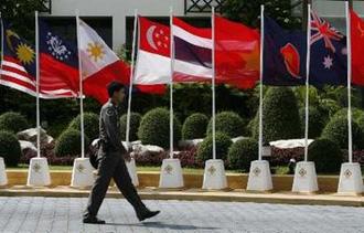 A security officer walks past the flags of member countries attending the 14th ASEAN Summit and Related Summits in Pattaya April 9, 2009.REUTERS/Claro Cortes IV
