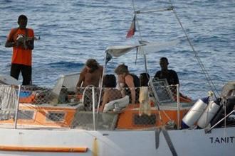 A picture released by the French army off the Somalian coast shows pirates and hostages on the boat, the Tanit, that was seized by Somali pirates on April 4. (AFP/Ecpad)