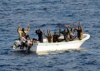 Suspected pirates hold up thir hands in the Gulf of Aden in February. Somali pirates seized two more ships, brushing off their losses from deadly rescue operations and throwing down the gauntlet to US President Barack Obama after he pledged to curb piracy.(AFP/US Navy/File/Jason R. Zalasky)