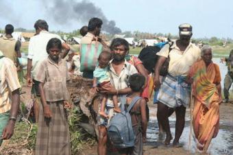 Civilians escape an area controlled by Tamil Tigers in north-eastern Sri Lanka in this photo taken on April 20, 2009.[Agencies]