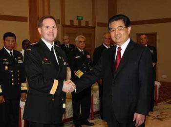 Chinese President Hu Jintao (R), also chairman of the Central Military Commission, shakes hands with Canadian navy Rear-Admiral Tyrone Pile in Qingdao, east China's Shandong Province, on April 23, 2009. Hu Jintao met here Thursday with heads of foreign navy delegations attending celebrations marking the 60th anniversary of the founding of the Chinese People's Liberation Army (PLA) Navy. (Xinhua/Wang Jianmin) 