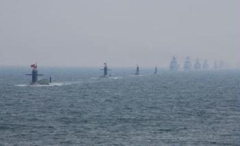 A naval parade of the Chinese People's Liberation Army Navy warships is held in waters off Qingdao, east China's Shandong Province, on April 23, 2009. The parade displayed 25 naval vessels and 31 aircraft of the PLA Navy, including two nuclear submarines, as part of a celebration to mark the 60th anniversary of the founding of the PLA Navy. (Xinhua/Zha Chunming)
