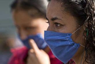 A woman wears a mask to prevent from being infected by the swine flu virus in the Mexico City, capital of Mexico, April 25, 2009. The World Health Organization (WHO) on Saturday declared the swine flu outbreak in Mexico and the United States a "public health emergency of international concern" and urged countries to be alert. (Xinhua Photo)