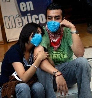A young couple wear surgical masks in Mexico City. Mexico has begun a five-day shutdown to try to halt the spread of A/H1N1 flu as the country was approved for three billion dollars in international loans to fund its battle against the virus.(AFP/Getty Images/Joe Raedle) 