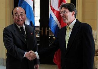 DPRK's Foreign Minister Pak Ui Chun, left, shakes hands with Cuba's Foreign Minister Bruno Rodriguez at the Foreign Ministry in Havana, Monday, May 4, 2009.(AP Photo/ Ismael Francisco, Prensa Latina)