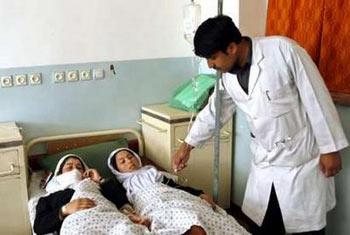 A doctor checks on female students in a hospital in Charikar city, May 11, 2009.REUTERS/Omar Sobhani 