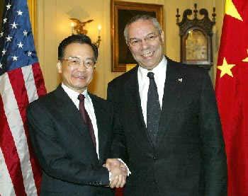 Visiting Chinese Premier Wen Jiabao shakes hands with US Secretary of State Colin Powell in Washington on December 9, 2003. [China-embassy.org ]