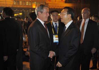 US President George W. Bush (C) shakes hands with Chinese Foreign Minister Yang Jiechi upon his arrival on August 7, 2008 at Beijing Capital International Airport. [Xinhua]
