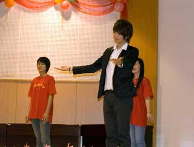 Song Xiaobo, a contestant in "My Hero," teaches sign language at the ceremony.