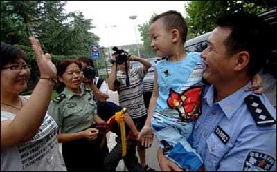 Lang Zheng (2nd R), known as the "Salute Boy", leaves Tangdu Hospital after two months of treatment, in Xi'an, capital of northwest China's Shaanxi Province, July 27, 2008. Lang, from the Qushan Township Kindergarten of Beichuan Qiang Autonomous County in southwest China's Sichuan Province, was rescued from the debris after the May 12 Wenchuan earthquake. After being put on a stretcher, the injured and fragile boy slowly raised his right hand and saluted his rescuers in gratitude. The moment was captured by a photographer and moved the whole nation. His fractured left arm and partly amputated left fingers have been recovering well during the two months at Tangdu Hospital.