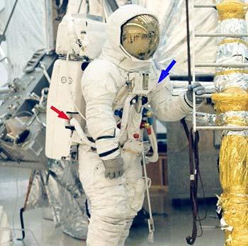 (Above) Apollo 13 astronaut James Lovell during EVA training. The blue arrow points to the RCU. The red arrow points to where the RCU umbilical connected to the PLSS. Detail from NASA photo AP13-KSC-70PC-12.