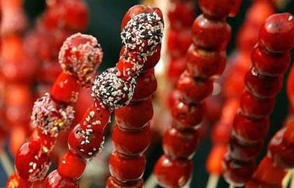 Sugar-Coated Haws on a stick (Bing Tang Hu Lu) is sold everywhere in cold days and is one of the daintiest snacks.