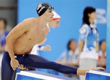 US swimmer Eric Shanteau stretches on the starting block before his semi-final race in the men's 200 meters breaststroke during the swimming competitions in the National Aquatics Center at the Beijing 2008 Olympics in Beijing, Wednesday, Aug. 13, 2008. The American swam a personal best in Wednesday's semifinals of the 200-meter breaststroke but it wasn't enough to advance to Thursday's final. The 24-year-old swimmer will now return to Atlanta for surgery on the testicular cancer he was diagnosed with a few weeks before last month's U.S. trials.(AP Photo/Mark J. Terrill) 
