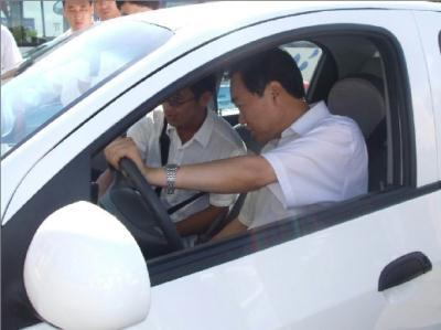 Xia Deren, general secretary of the Dalian committee of the Communist Party of China, is seen in an electric motor car for a test drive, in Dalian, a coastal city in Northeastern China. The new energy vehicles, one of the highlights of the Summer Davos, will be used during the meeting. 
