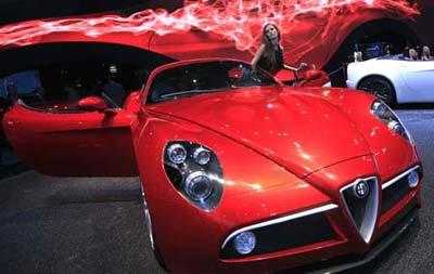 A model poses beside Alfa Romeo's sportscar 8C at the Paris Mondial de l'Automobile on media day October 3, 2008. The Paris Auto show opens its doors to the public from October 4 to October 19.(Xinhua photo)