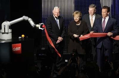 Intel Chairman Craig Barrett (L-R), German Chancellor Angela Merkel, Lower Saxony Premier Christian Wulff and California Governor Arnold Schwarzenegger cut the ribbon with robot Marvin during the opening ceremony of the CeBIT computer fair in the northern German town of Hanover March 2, 2009. The world's biggest IT fair CeBIT with 4300 exhibitors from 69 countries opens its doors to the public on March 3, and runs through March 8, 2009.(Xinhua/Reuters Photo)