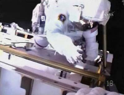 Astronaut Steve Swanson is seen in this view from the helmet camera of fellow spacewalker Richard Arnold as the pair work to install the International Space Station's new truss assembly and solar array in this image from NASA TV March 19, 2009. (Xinhua/Reuters Photo)