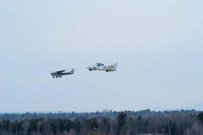 A flying car named Transition (right) hovers over the test field with a chase aircraft at Plattsburgh International Airport in Plattsburgh, New York, March 5, 2009. [CFP]