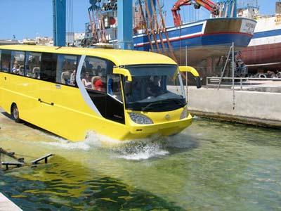 The world's first amphibious coach has been launched in Rotterdam, the Netherlands, thanks to Scotsman George Smith. The Amphicoach, which has seats for 50 passengers, allows bus passengers to take to the waves. The vehicle drives like a traditional coach until it reaches water, where its makers say it exhibits 'astonishing' sailing abilities. Its hull is made from 6mm marine-grade aluminium and it is powered in the water by a jet-drive unit. The coach's wheels are retracted into the hull to reduce drag and allows it to reach speeds of up to 8 knots. [CFP]