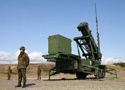 Japan Ground Self-Defense Force personnel stand around PAC-3, land-to-air missile, set up at a base amid the Democratic People's Republic of Korea's planned rocket launch in Akita, northern Japan, Tuesday, March 31, 2009. Batteries of PAC-3 land-to-air missile interceptors have been sent to two northern prefectures that the Democratic People's Republic of Korea's rocket is expected to fly over.(Xinhua/AFP Photo)