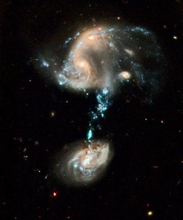 This image provided by NASA Tuesday April 21, 2009 shows a peculiar system of galaxies known as Arp 194. This interacting group contains several galaxies, along with a 'cosmic fountain' of stars, gas, and dust that stretches over 100,000 light-years. The most striking feature of this galaxy troupe is the impressive blue stream of material extending from the northern component. This 'fountain' contains complexes of super star clusters, each one of which may contain dozens of individual young star clusters. The blue color is produced by the hot, massive stars which dominate the light in each cluster. Overall, the 'fountain' contains many millions of stars. This picture was issued to celebrate the 19th anniversary of the launch of the Hubble Space Telescope aboard the space shuttle Discovery in 1990. During the past 19 years Hubble has made more than 880,000 observations and snapped over 570,000 images of 29,000 celestial objects. The Space Shuttle Discovery placed the Hubble Space Telescope into Earth orbit on April 25, 1990. (Photo: NASA)
